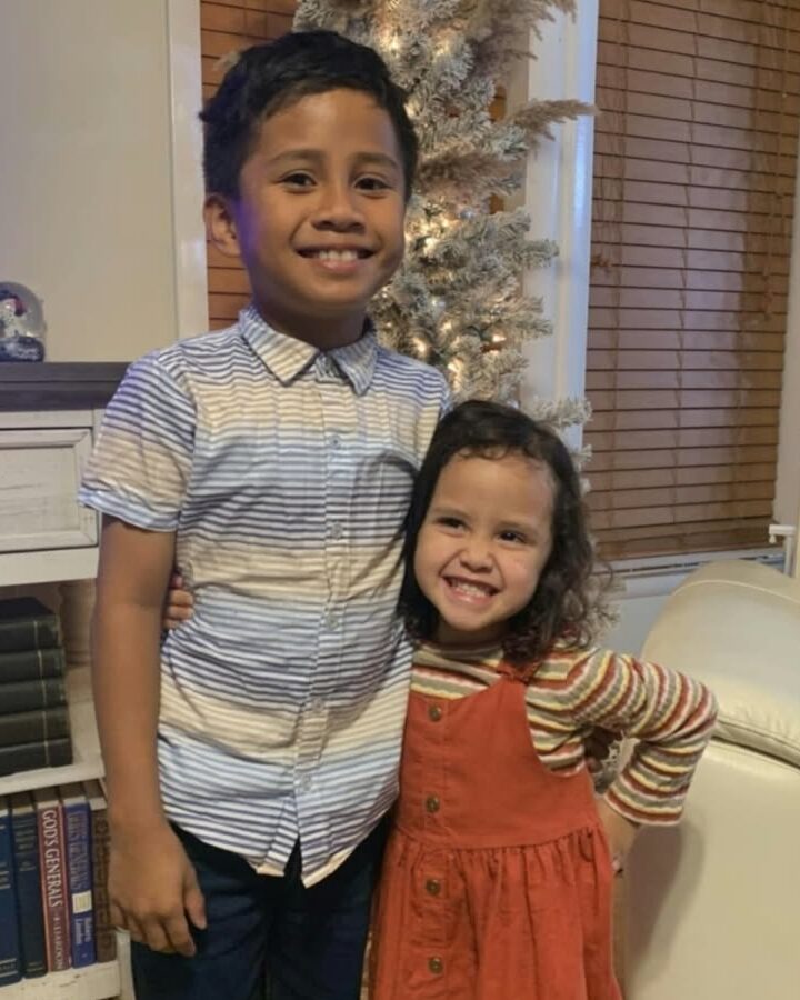 Photo of Kenoy and Mahalia smiling at home, his arm around her